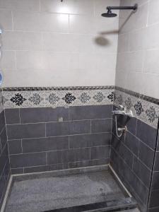 a shower with a gray and white tiled wall at Playa Hotel in Dahab +21 photos