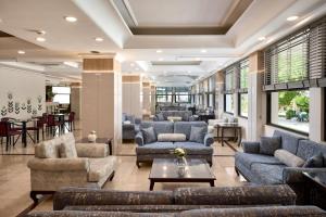 a lobby with couches and chairs and a table at Club Titan Hotel Ultra All Inclusive in Kargicak