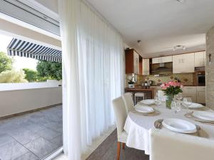 a kitchen and dining room with a table and chairs at Holiday Home Karlo by Interhome in Posedarje