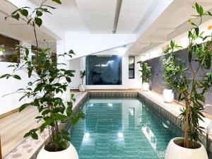 a swimming pool in a house with potted plants at Super Star Midak Mews 2 in Lekki