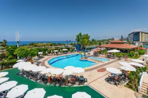 an aerial view of a resort pool with umbrellas and chairs at Club Titan Hotel Ultra All Inclusive in Kargicak