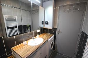 a bathroom with a sink and a mirror at Close Palais - Calm - Brand New in Cannes +18 photos