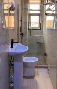 a bathroom with a sink and a toilet and a shower at Super Star Midak Mews 2 in Lekki +5 photos