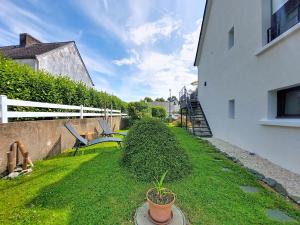 a garden with a bench on the side of a building at Apartment Ty PJP by Interhome in Névez