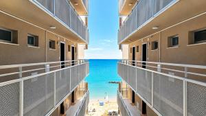 a view of the beach from the balcony of a hotel at SkyMare - Beachfront Sea View Apartment in Porto San Giorgio