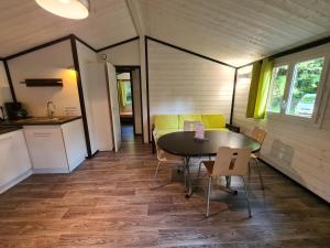 a dining room with a table and chairs in a room at Les Buissonnets in Saint-Georges-de-Didonne +12 photos