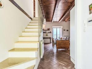 a staircase in a home with a dining room and a table at Apartment Laghina by Interhome in Musso +16 photos