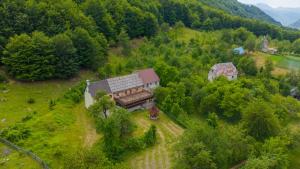 an aerial view of a house on a hill with trees at Hotel Shen Klementi in Vermosh