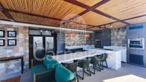 a rendering of a kitchen with a bar and chairs at Makani Beach Campas - Praia de Tamandaré in Tamandaré