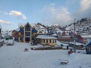 a small town in the snow with buildings at Hotel sangam kalinchok kuri in Dolakhā