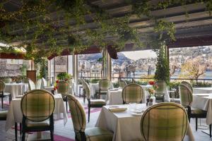 a restaurant with tables and chairs with a view at Albergo Terminus in Como