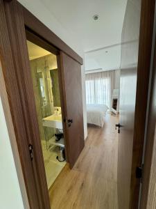 an open door to a bedroom with a bed and a sink at Charming apt with terrace in Kenitra +22 photos