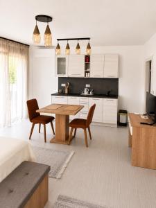 a kitchen and living room with a table and chairs at Apartments Villa Rosa in Rovinj