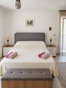 a bedroom with a large bed with two pillows on it at Apartments Villa Rosa in Rovinj