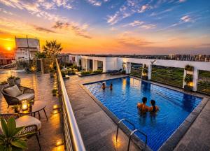 a pool on the roof of a building with people in it at weston Hotel And Resorts in kolkata