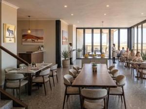 a restaurant with tables and chairs and people eating at Aggeneys Hotel in Aggeneys