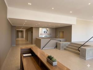 a lobby with stairs and a sign in a building at Aggeneys Hotel in Aggeneys