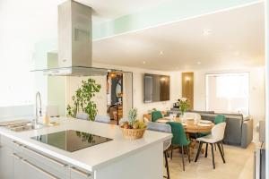 a kitchen and living room with a table and chairs at Maison d'hôtes avec Jacuzzi -Sauna in Montreux-Château