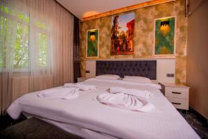 a bedroom with a large white bed with towels on it at Mar Boutique Apartment in Istanbul +129 photos