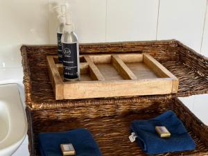 a basket with a bottle of soap and two towels at Kobe Mara in Talek