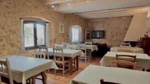 a restaurant with tables and chairs in a room at Can 28 in Torroella de Montgrí