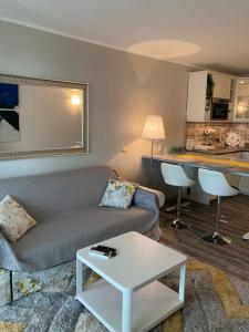 a living room with a couch and a table and a kitchen at Balchik Sea View Studio in Balchik