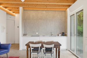 a kitchen with a wooden table and chairs at Pai 521 openspace in Torri del Benaco +22 photos