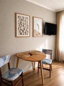 a dining room with a table and two chairs at Belona in Stegna +16 photos