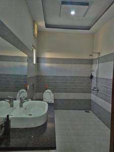 a bathroom with a sink and a toilet at Stillers Residency in Rahimyar Khan