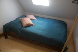 a bed with two pillows on it in a room at Chata U3G Kobyly-Mlynky in Kobyly +10 photos