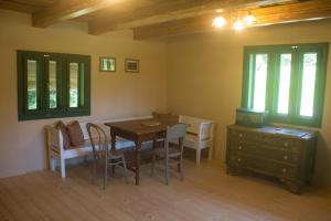 a dining room with a table and chairs and a desk at Chata U3G Kobyly-Mlynky in Kobyly