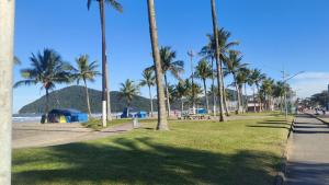 a park with palm trees next to the beach at Apê d'praia 31 - Beira Mar Bertioga in Bertioga
