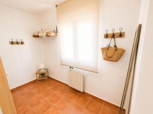 a bathroom with a window and a tile floor at Chalet con piscina y barbacoa, Valencia in Torrent +21 photos