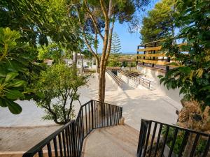 a skate park with a black railing and trees at Chalet con piscina y barbacoa, Valencia in Torrent