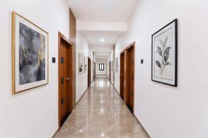 a hallway with paintings on the walls at FabHotel DSP in Pune