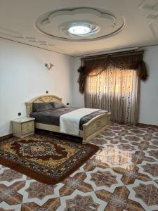 a bedroom with a bed and a ceiling at Appartements dior al hoceima in Al Hoceïma