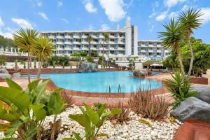 a resort with a swimming pool and a building at GOLF Villa233 in San Miguel de Abona