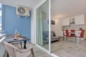 a living room with a table and chairs and a dining room at GOLF Villa233 in San Miguel de Abona