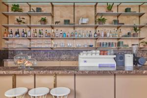 a bar with two stools and a counter with bottles at Eden Locke in Edinburgh