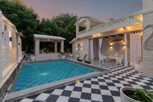 a swimming pool in the backyard of a house at Emerald Hill Villa by Jodhani in Udaipur
