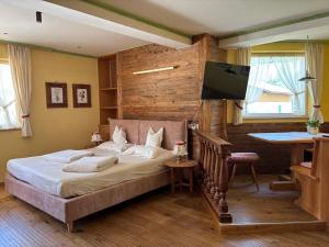 a bedroom with a bed and a flat screen tv at Residence Intica in San Candido