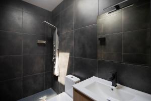 a bathroom with a sink and a toilet and a shower at Villas 21 in Nosy Be