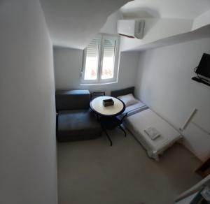 a small room with a couch and a table at Apartman Vuk in Budva