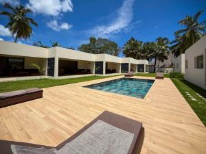 a swimming pool in the backyard of a house at Villas 21 in Nosy Be