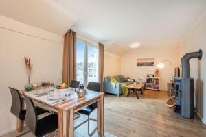 a living room with a table and a living room with a couch at Ückeritz Sylva in Ueckeritz
