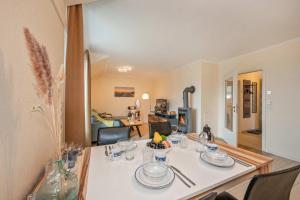 a dining room table with a white table cloth at Ückeritz Sylva in Ueckeritz +15 photos