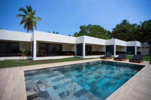 an exterior view of a villa with a swimming pool at Villas 21 in Nosy Be