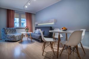 a living room with a table and chairs and a couch at Apartamenty Nautilus in Świnoujście