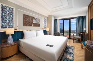 a bedroom with a large white bed and a large window at Aspera Hotel Taksim in Istanbul
