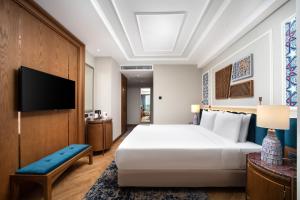 a bedroom with a large bed and a flat screen tv at Aspera Hotel Taksim in Istanbul